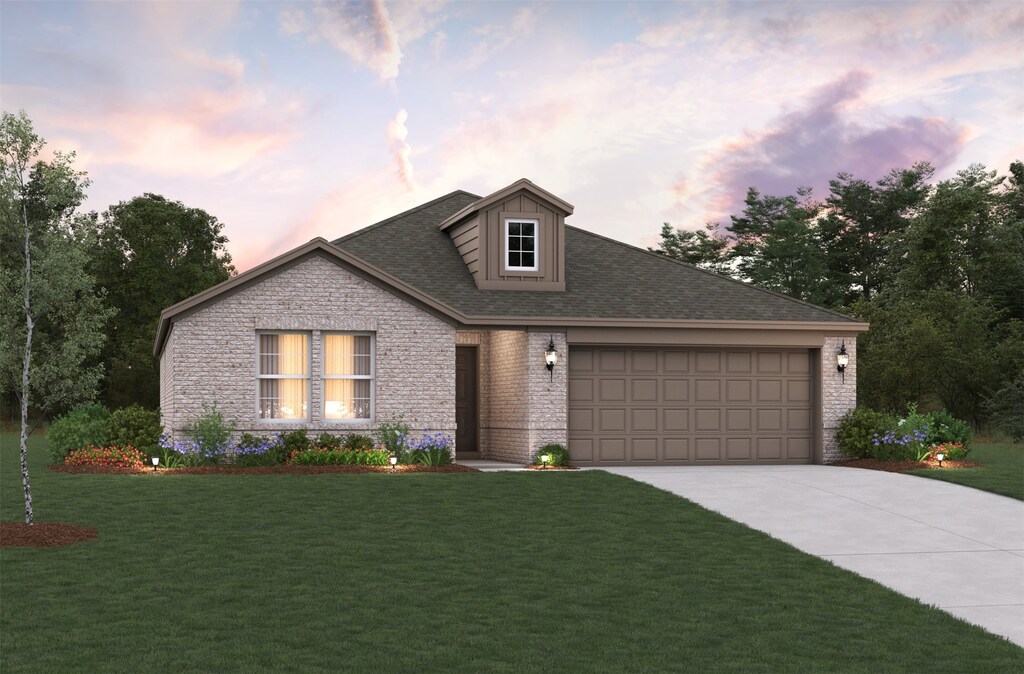 view of front of home featuring a garage and a lawn