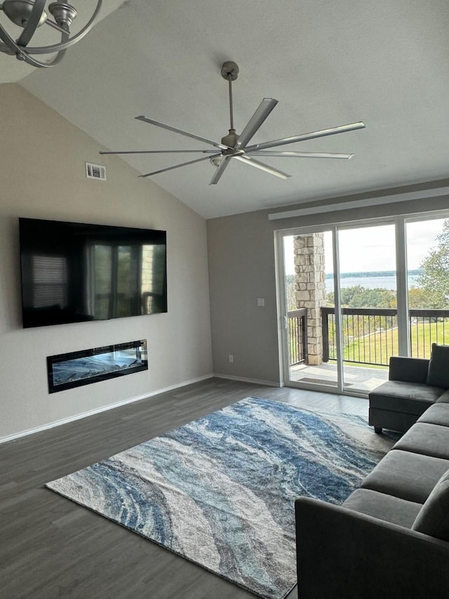 living room featuring ceiling fan, lofted ceiling, and dark hardwood / wood-style flooring