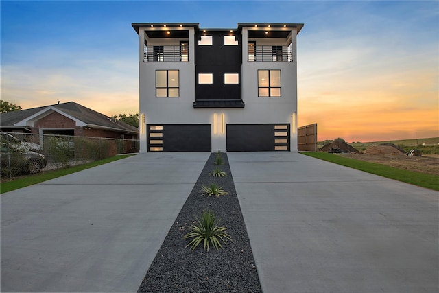 contemporary house featuring a balcony and a garage