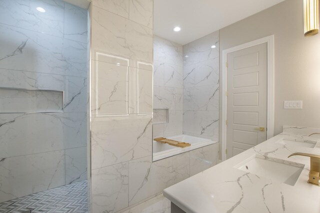 bathroom with a tile shower and vanity