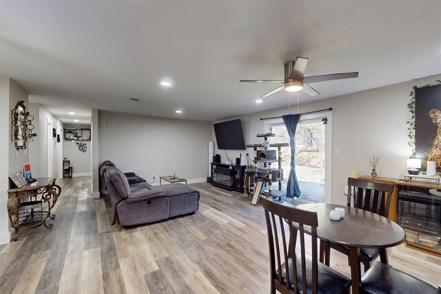 living room featuring ceiling fan and wood-type flooring