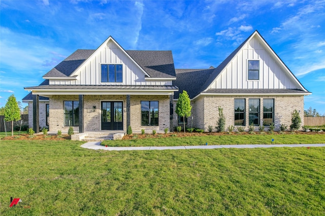 modern farmhouse style home with a porch and a front lawn