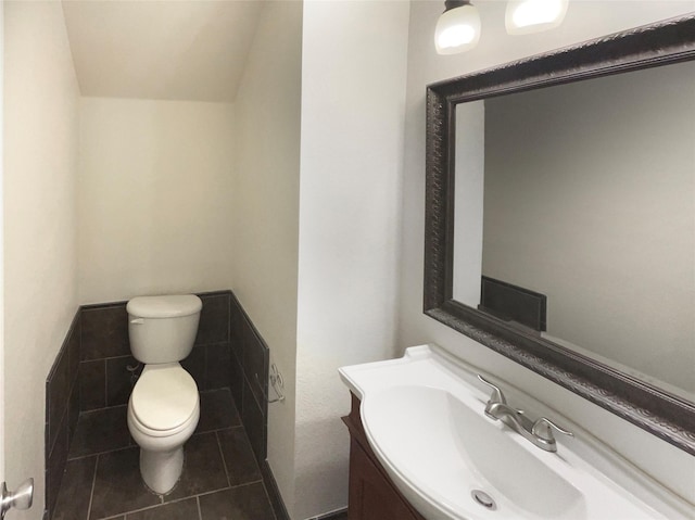 bathroom with vanity, tile patterned flooring, and toilet