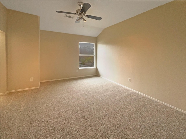 spare room with ceiling fan, lofted ceiling, and carpet flooring