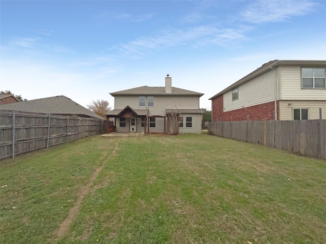 back of property featuring a lawn