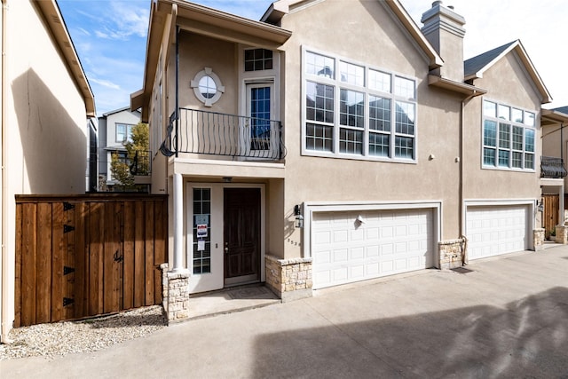 view of property featuring a balcony and a garage