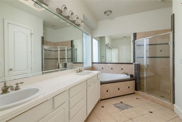 bathroom with vanity, tile patterned flooring, and plus walk in shower