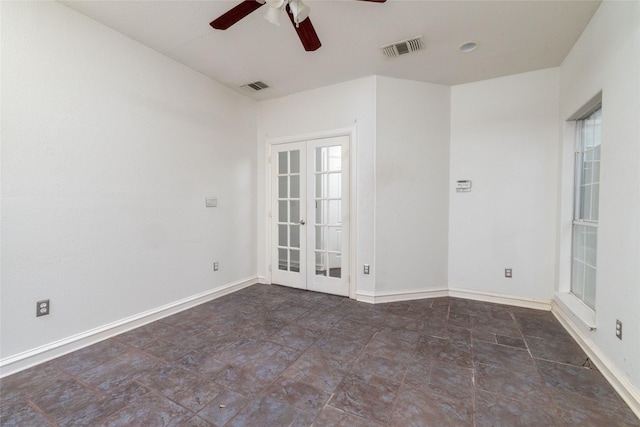 spare room with plenty of natural light, ceiling fan, and french doors