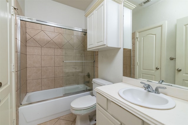 full bathroom featuring tile patterned flooring, vanity, enclosed tub / shower combo, and toilet