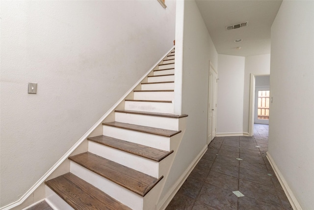 stairway featuring tile patterned flooring