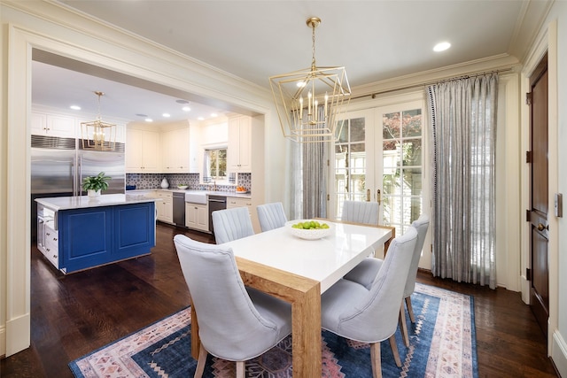 dining room featuring dark hardwood / wood-style flooring, french doors, a chandelier, and ornamental molding