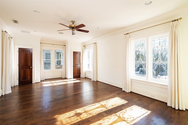 empty room with dark hardwood / wood-style flooring, plenty of natural light, crown molding, and ceiling fan