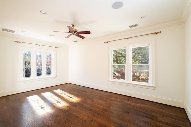 spare room featuring ceiling fan, ornamental molding, and dark wood-type flooring