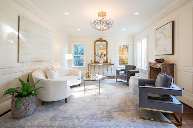 sitting room with crown molding, a chandelier, and hardwood / wood-style flooring