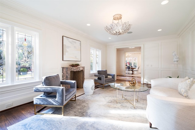 living area featuring plenty of natural light, dark hardwood / wood-style flooring, and ornamental molding