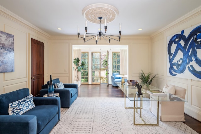 living room with crown molding, light hardwood / wood-style flooring, and a notable chandelier