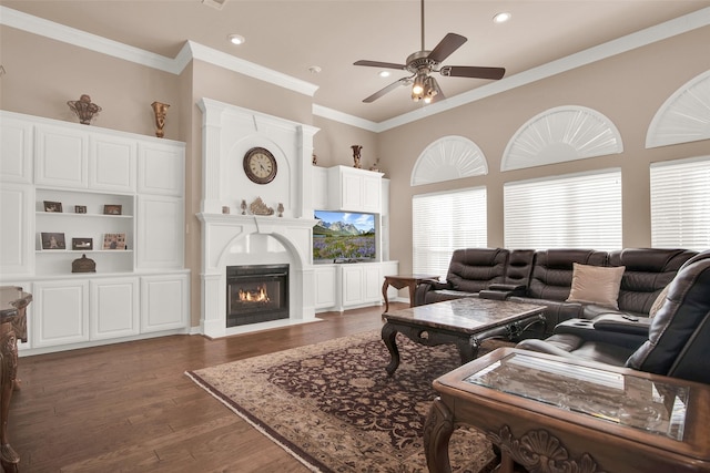 living room with dark hardwood / wood-style flooring, ornamental molding, and ceiling fan