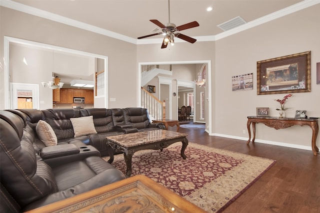 living room featuring crown molding, dark hardwood / wood-style floors, and ceiling fan with notable chandelier