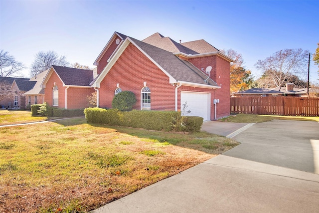 view of front of home with a garage and a front lawn