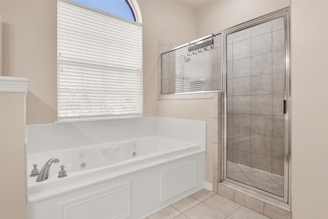 bathroom featuring tile patterned flooring and shower with separate bathtub