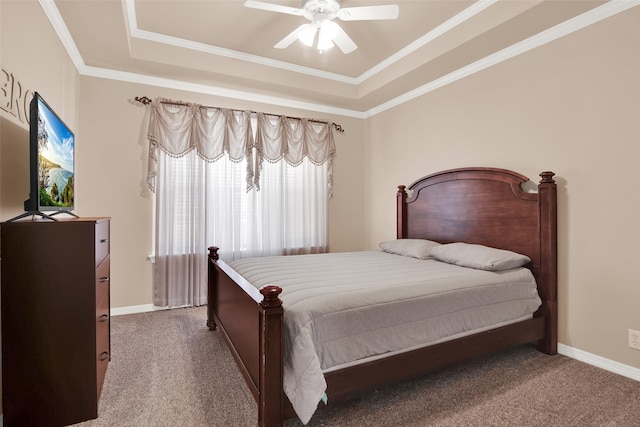 bedroom featuring crown molding, a raised ceiling, ceiling fan, and carpet flooring