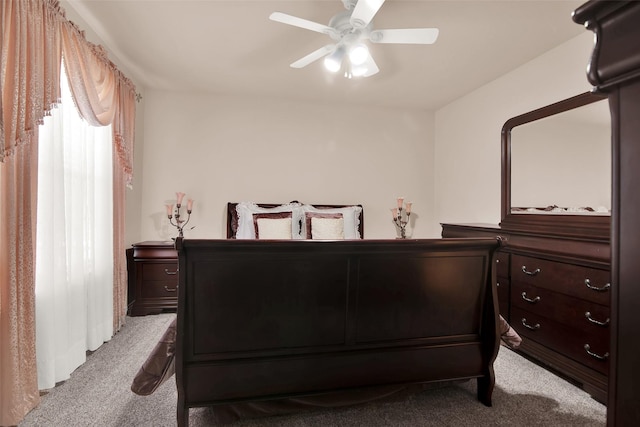 bedroom with light carpet and ceiling fan