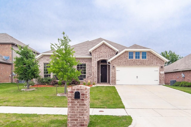 view of front of home with central AC unit, a garage, and a front yard