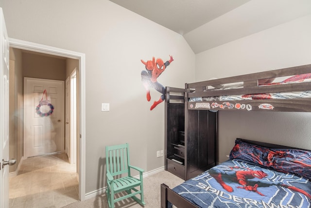 carpeted bedroom featuring lofted ceiling