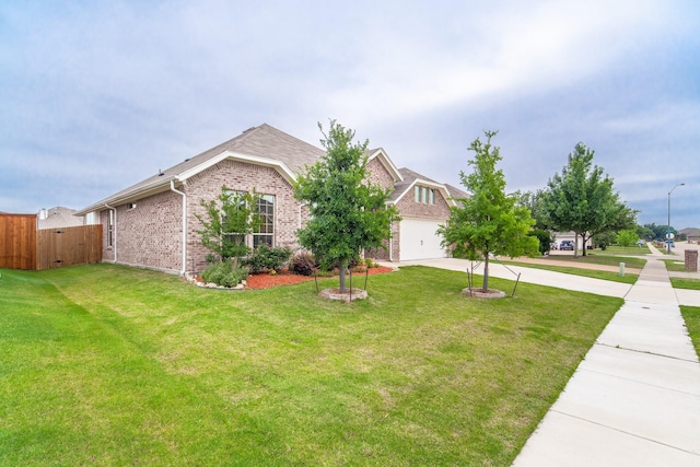 view of front of home with a garage and a front lawn