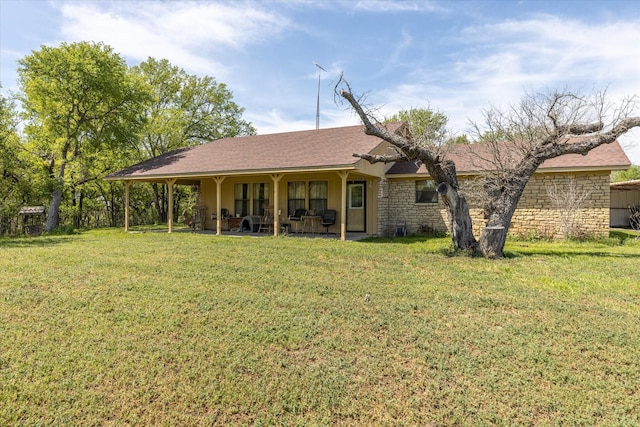 rear view of property featuring a yard