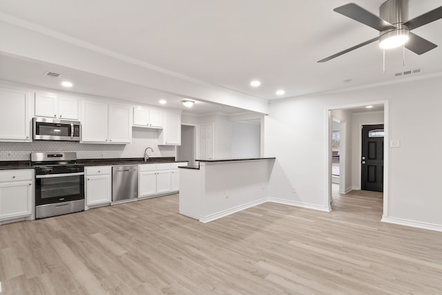 kitchen with white cabinetry, ceiling fan, tasteful backsplash, appliances with stainless steel finishes, and light wood-type flooring