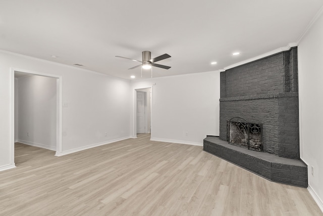 unfurnished living room featuring ceiling fan, light hardwood / wood-style floors, ornamental molding, and a fireplace