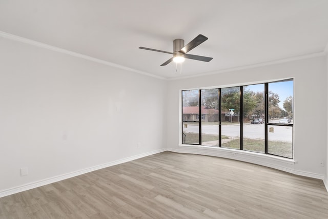 empty room featuring ceiling fan, light hardwood / wood-style floors, and crown molding