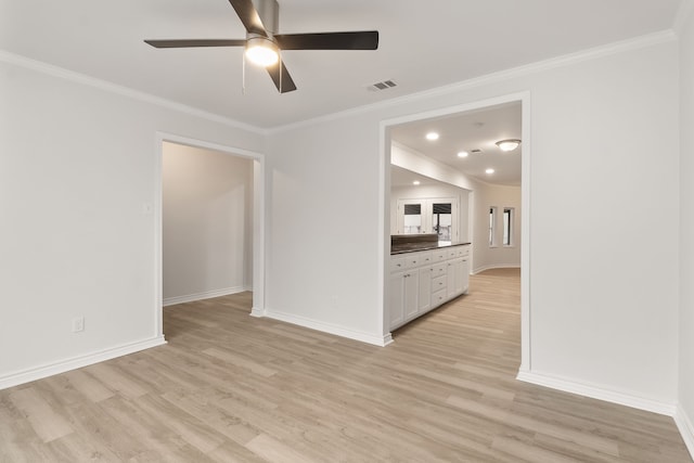 unfurnished living room featuring ceiling fan, crown molding, and light hardwood / wood-style flooring