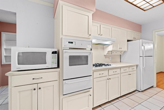 kitchen featuring white cabinets, white appliances, and light tile patterned floors