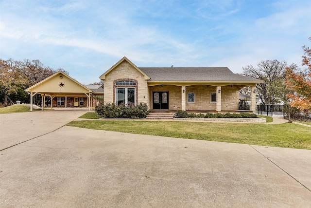 view of front facade with french doors, a front lawn, and a carport