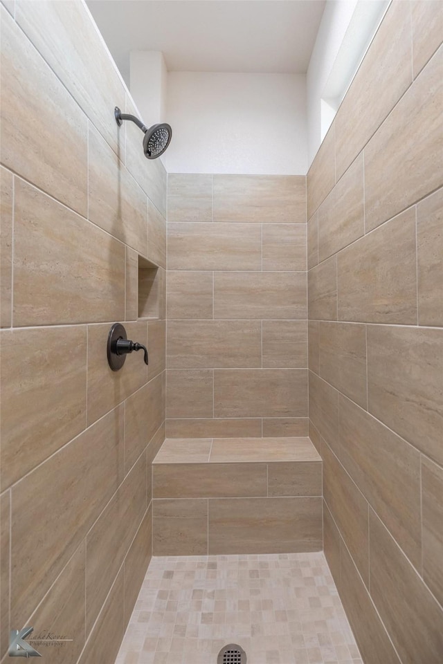 bathroom with tiled shower