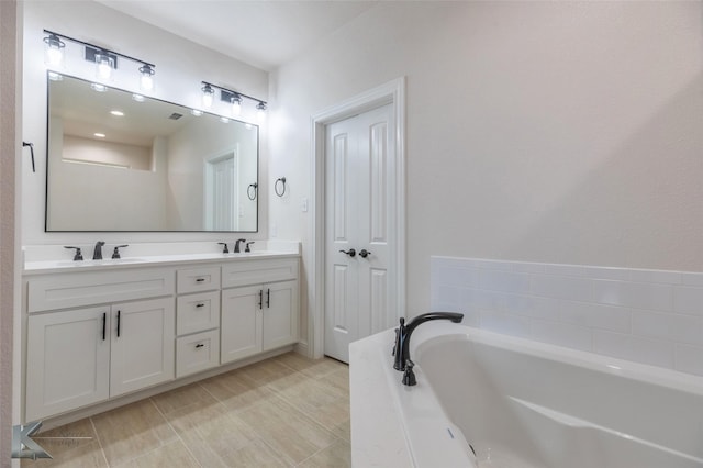 bathroom with vanity and a bathtub