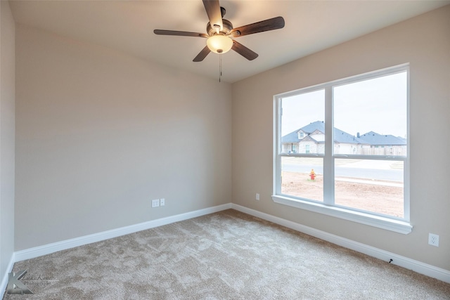 carpeted spare room with ceiling fan