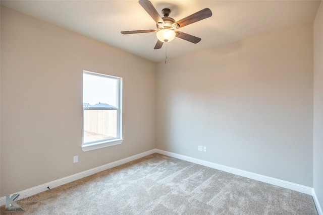 empty room with light colored carpet and ceiling fan