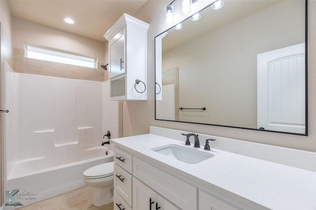 full bathroom with vanity, tub / shower combination, wood-type flooring, and toilet