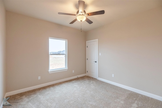 carpeted spare room featuring ceiling fan