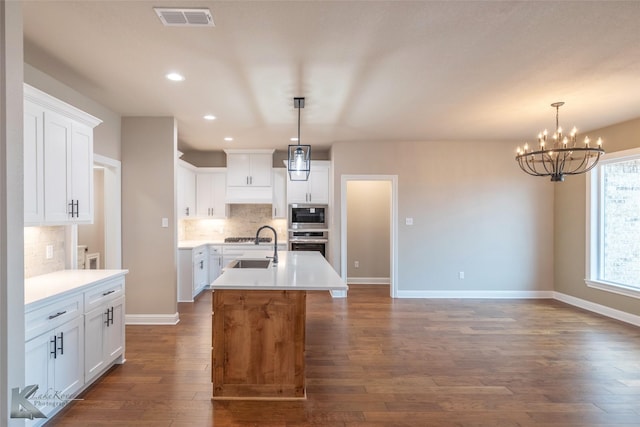 kitchen featuring white cabinetry, stainless steel appliances, and decorative backsplash