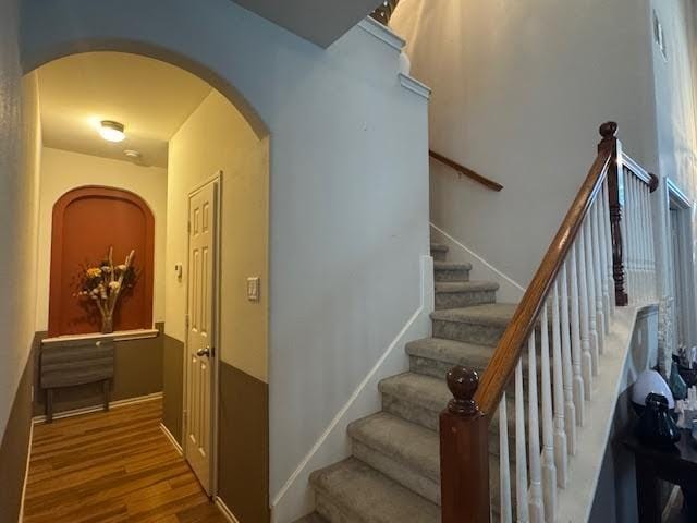 stairway with hardwood / wood-style floors