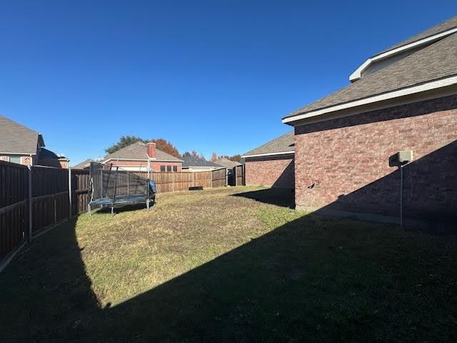 view of yard featuring a trampoline