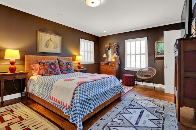 bedroom with wood-type flooring and ornamental molding