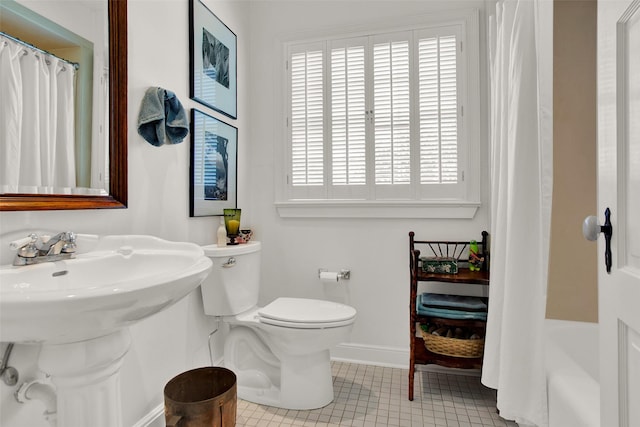 full bathroom featuring tile patterned flooring, shower / bath combination with curtain, toilet, and sink