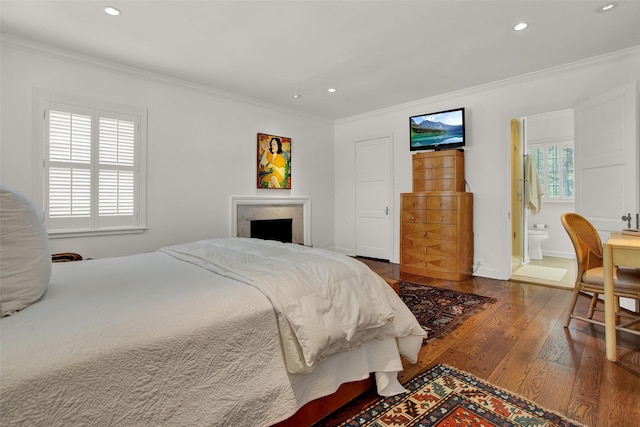 bedroom with hardwood / wood-style flooring, multiple windows, crown molding, and ensuite bathroom