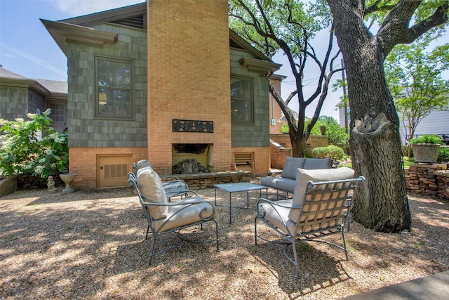 view of patio / terrace featuring an outdoor stone fireplace