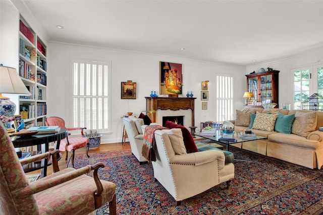 living room featuring hardwood / wood-style floors and crown molding